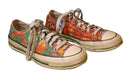 Colorful vintage sneakers with artistic designs and white laces.